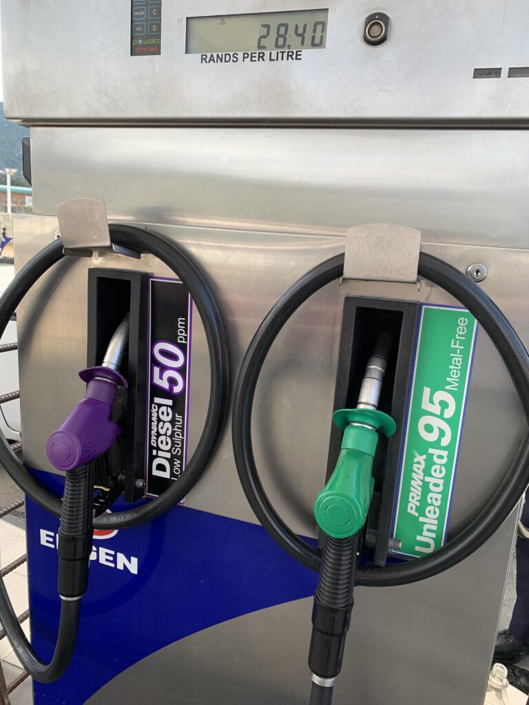Fuel pump showing diesel and unleaded petrol nozzles with price displayed at R28.40 per litre.